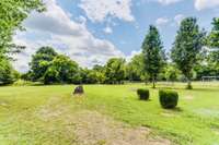 Expansive lot with mature trees, offering plenty of space for outdoor activities!