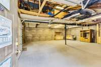 Versatile garage space with ample room for storage, hobbies, or a workshop setup.