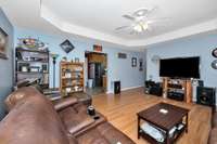 Living Room- laminate flooring, trey ceiling, ceiling fan