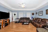 Living Room- laminate flooring, trey ceiling, ceiling fan