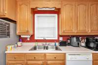 Kitchen - linoleum flooring, wood cabinets