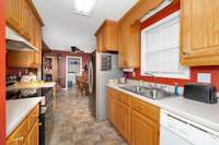 Kitchen- linoleum flooring, wood cabinets