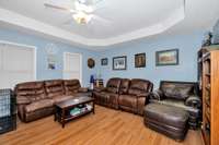 Living room- laminate flooring trey ceiling, ceiling fan