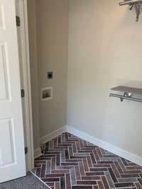 The washer & dryer will remain in this laundry area.  Love the flooring!