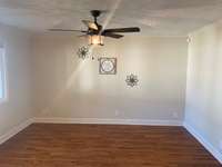 Enjoy a spacious living room with large windows for great lighting!  Lovely hardwood!