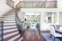 Grand entryway with a beautiful staircase leading upstairs.