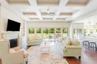 Huge living room with a beautiful view of your property through all of these windows.