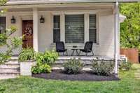 Picturesque front porch overlooking this quaint sidewalk, treelined street.