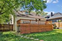 Oversized backyard with canopy trees and plenty of room for a pool.