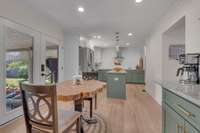 Lots of lights in this gorgeous kitchen with French doors leading out to outdoor kitchen.