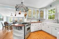 The kitchen is light and bright, with updated quartz countertops, farmhouse sink, and plenty of storage.