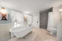 The primary bathroom features pennytile, updated shower, double vanities, and circa 1911 clawfoot tub that was recently reglazed.