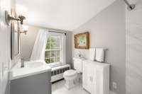 The guest bathroom upstairs features a spacious layout and new shower.