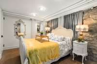 The second bedroom in the basement is also a great size. Notice the charming stone walls continue throughout the basement.