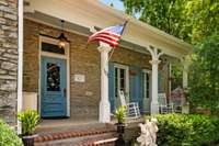 A picturesque front porch welcomes you to this grand property.