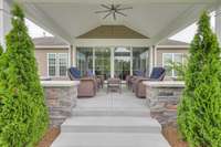 Sliding doors open to sunroom area inside home