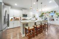 Kitchen flows into the living space separated by a large island.