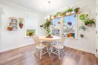 The eat in area in the kitchen has ample light and a door to the 400 square foot covered porch.