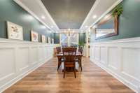 Large dining area with wainscoting, trey ceiling, and upgraded lighting.