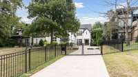 Electric gate encloses the fully fenced in front yard.