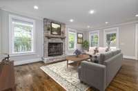 Spacious living room with natural light and wood burning fireplace. This photo is virtually staged.