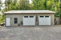 3rd. 2 Car Garage (SHOP) with Water, Electric, 220 Amp voltage.  Door to the left leads to Large Room with Full Bath that has been plumbed and Electrical installed.