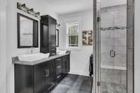 Beautiful owners bath with custom shower, double vanities & oversized tub.  Notice the beautiful detail in the shower.