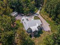 Looking down on the back side of the home. 2nd. 2 car garage (that's heated) is on the righthand side. Back yard is fenced.  Also, fenced garden area.