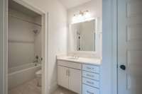 Tiled Shower, Travertine countertop.