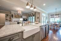 Large kitchen island with farmhouse sink, DW and Beverage Center (aka wine fridge).