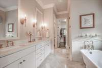 Master Bath with Marble Tops and Travertine Floors. Living Brass fixtures.