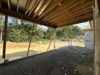 View of Grilling Porch and private  backyard.  *this home is under construction  Photo Taken 8/15/24