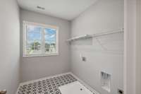 Tiled Laundry located at the top of the stairs. Beautiful natural light in this room!