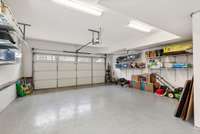 Garage has epoxy floor, shelving remains, door opener and double depth for 3 cars.