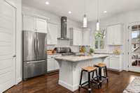 Pantry, stone counters, stainless appliance package, this classic white kitchen is perfectly appointed