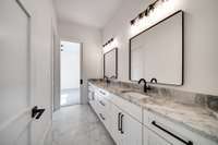 Spacious bathroom with dual vanities.