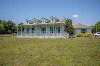 Wrap around porch looks out over the pasture.