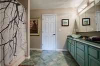 Shower/bath and double sinks and ceramic tile in bathroom of Barndominium.