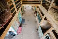 Looking down into the 8 stall barn.  Wash area, lower left of picture, then tack/feed storage area.