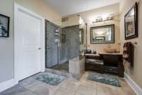 The master bath features a large glassed in shower and a nice decorative basin/sink.