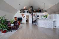 Barndominium interior view. Kitchen, Living, and Loft area. Also door going into the main level  bedroom.