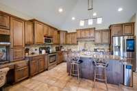 There are so many beautiful kitchen cabinets and the island where you can pull up your own bar stools.