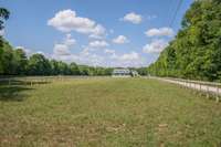 Nice level, fenced, and cross fenced farm with single level home and barndominium.