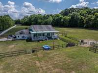 View of the back of the home at 2290 Osborn Rd, Arrington, TN.  Fencing and cross fencing for animals and pets.