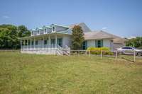 4 Gable roof design, wrap around porch, and 2 car garage.