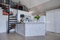 Spiral stairs up to the Loft Area. Convenient kitchen area and nice cabinets/storage area.