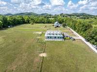 Nicely designed home with wrap around, covered porch and double garage, plus additional parking for visitors.