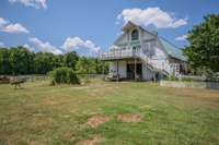 Barndominium with 8 stall barn, tack room,1/2 bath, and 2 bedroom, 1 bath loft apartment.