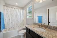 The Private Bath features tile flooring, vanity with granite countertop, shower/tub combo, and walk-in closet.