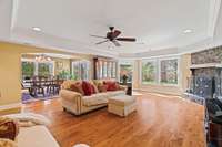 Spacious living room features a wood burning fireplace and lots of natural light.